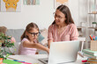 © Pixel-Shot - Cute little girl doing lessons with her mother at home