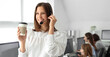© Pixel-Shot - Female technical support agent with coffee at office