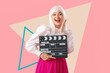 © Pixel-Shot - Beautiful actress in wig with movie clapper on pink background