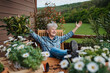 © Halfpoint - Senior woman with coffee sitting on terrace, resting after gardening.