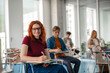© Halfpoint - Group of college students attending lecture in university hall.