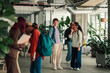 © Zamrznuti tonovi - Diverse students walking through a modern university campus building, learning and networking in a community environment