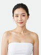 © Vasiliy - Portrait of a young Asian woman with glowing skin. Female model wearing a white strapless top and gold necklace on a white background. Natural beauty and skincare concept