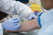 © .shock - Young doctors and medical technician performing blood draw in clinical laboratory setting