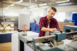 © Geber86 - Man operating industrial printing machine in factory workshop