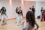 Diverse group of people practicing urban dance choreography in studio