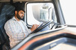 © Serhii - Indian truck driver documenting delivery details