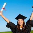 © Suphitcha - Celebratory Graduate Holding Diploma with Joy and Pride Outdoors