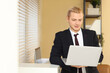 © Pixel-Shot - Young businessman working with laptop in office