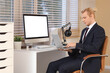 © Pixel-Shot - Young businessman working with laptop at desk in office