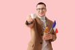 © Pixel-Shot - Young man with French flag, croissant and cup of coffee on pink background