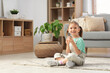 © Pixel-Shot - Cute little girl with glass of water sitting on floor at home