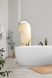© Pixel-Shot - Interior of light room with bathtub, mirror and plants