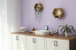 © Pixel-Shot - Shelves, chest of drawers with sink and bath supplies in interior of bathroom