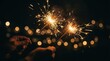 © Galadriel Gesso - Hands holding burning sparklers celebrating at night with warm bokeh lights