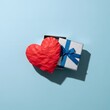 © MSTMAROFA - Gift and heart on light blue background a symbol of love and appreciation