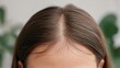 © 69 - Close-Up Photograph of a Woman's Hair with Natural Texture and Soft Lighting on a Neutral Background