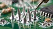 © arshad - Soldering iron soldering electronic components on a green circuit board
