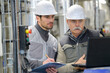 © auremar - two men working with laptop in factory
