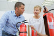 © auremar - woman demonstrating how to use a fire extinguisher