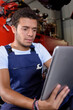 © auremar - a young mechanic using tablet