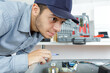 © auremar - young repairman fixing and repairing a machine