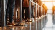 © dmmarychev - Queue of people standing behind metal stanchions in bright terminal