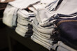 © andrey - Stacks of jeans in a clothing store ready for customers to browse