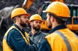 © Studio - A group of construction workers wearing hard hats talking to each other