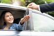 © Pormezz - transportation rental automotive business concept. Close up hands of rental auto agent giving car remote key to client to travel sightseeing.