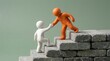 © Concept - Two figurines helping each other climb concrete stairs representing teamwork and support in personal or professional growth