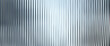 © TanyaFox - Silver acrylic ribbed glass texture background. Fluted plastic panel with soft blurred light reflections. Abstract translucent surface for modern design.