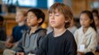 © Tania - Elementary students following guided imagery meditation led by counselor in sensory-friendly room with dimmed lights and calming wall colors, perfect for anxiety reduction therapeutic techniques