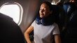 © Home-stock - Woman sitting comfortably on plane seat with her eyes closed, wearing neck pillow and resting during the flight, panorama
