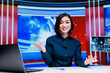 © DC Studio - Woman host on live tv show in newsroom, discussing about global communications and international events on broadcast. Reporter creating television content with breaking news segment.