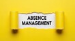 © Stocker Girl - Absence Management text on white background, torn yellow paper revealing human resources concept, workplace attendance and leave tracking strategy
