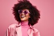 © juliars - Smiling woman with afro hairstyle wearing pink sunglasses and turtleneck