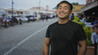 © Krakenimages.com - Young man points fingers down at restaurant terrace on cobblestone street with a welcoming grin; enthusiasm.