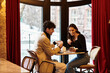 © LIGHTFIELD STUDIOS - Young couple shares sweet moments on a romantic date at a cozy restaurant