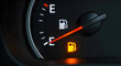 © atik100 - Low fuel warning a car's dashboard gauge indicates empty gas tank
