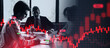 © Prostock-studio - Three people sit around a table in an office discussing stock market trends. They look at charts and papers. A digital graph displays buy and sell signals in the background.