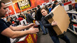 © Nei Mar - Woman holding large box while shopping during Black Friday sales