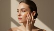 © ANDREY PROFOTO - Beautiful woman applying serum to glowing radiant skin