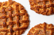 © Zuckerschock Studio - Three round apple pies with lattice crust on a white background