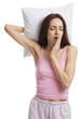 © New Africa - Woman with pillow yawning on white background