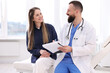 © New Africa - Woman having appointment with doctor in clinic