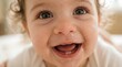 © Ohana - Cheerful Baby with Wide Eyes and Drooling Smile Close up Portrait