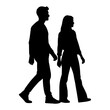 © Dhani - Silhouette of a man and woman walking together side by side.