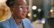 © peopleimages.com - Night, glasses or black woman in office with laptop, draft edit or fact checking in article review. Bokeh, specs or journalist in agency with tech, proofreading or industry research in overtime.