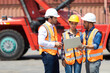 © NVB Stocker - Hispanic man harbor worker talking on the walkie-talkie radio and control loading containers at container warehouse. container yard port of import and export goods